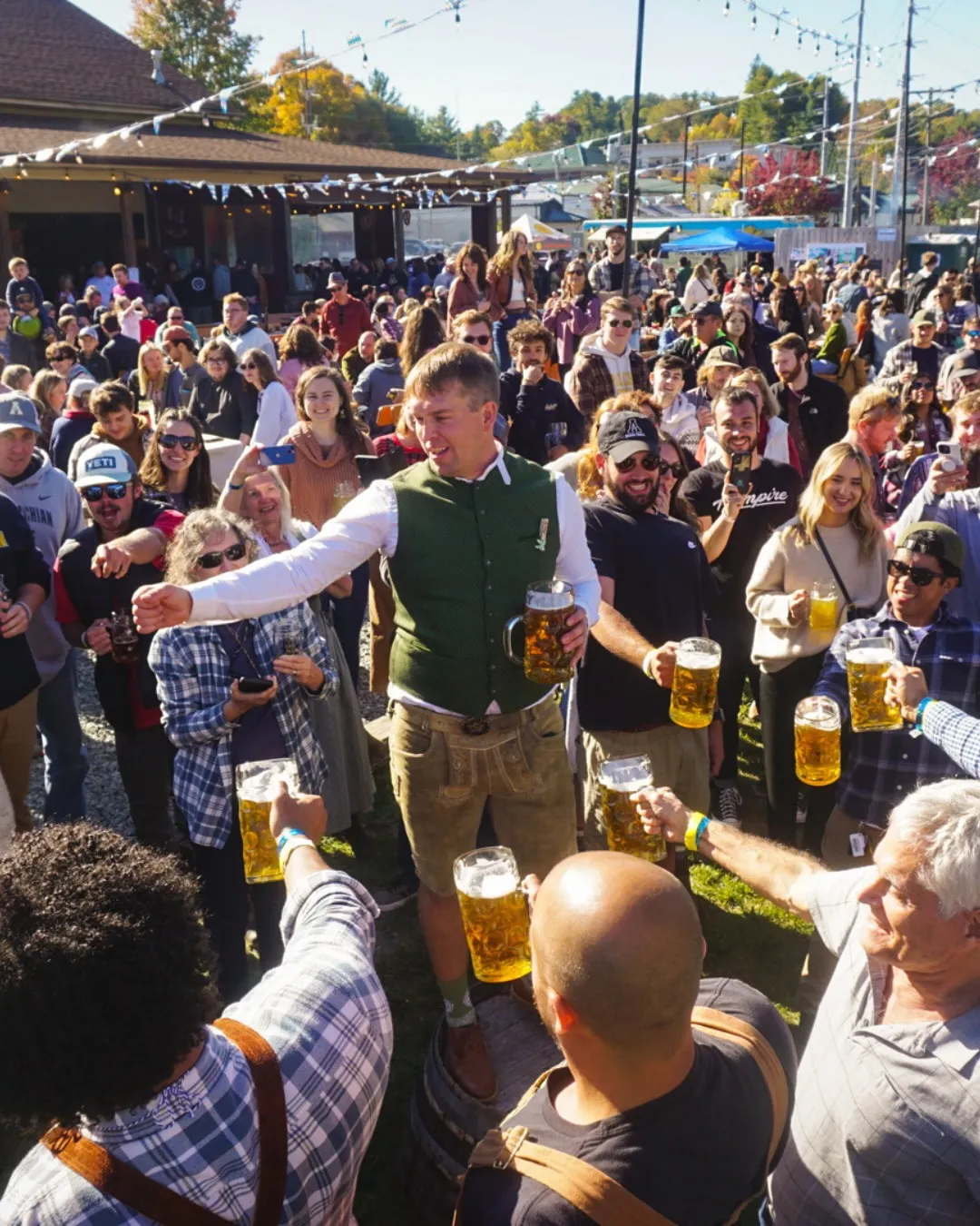 Crowd raising beer steins together at Appalachian Mountain Brewery
